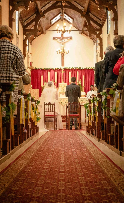 the bride and groom are sitting in front of the alter