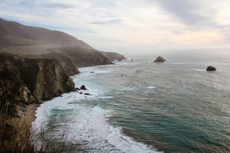 the ocean is surrounded by rocky cliffs and white sand