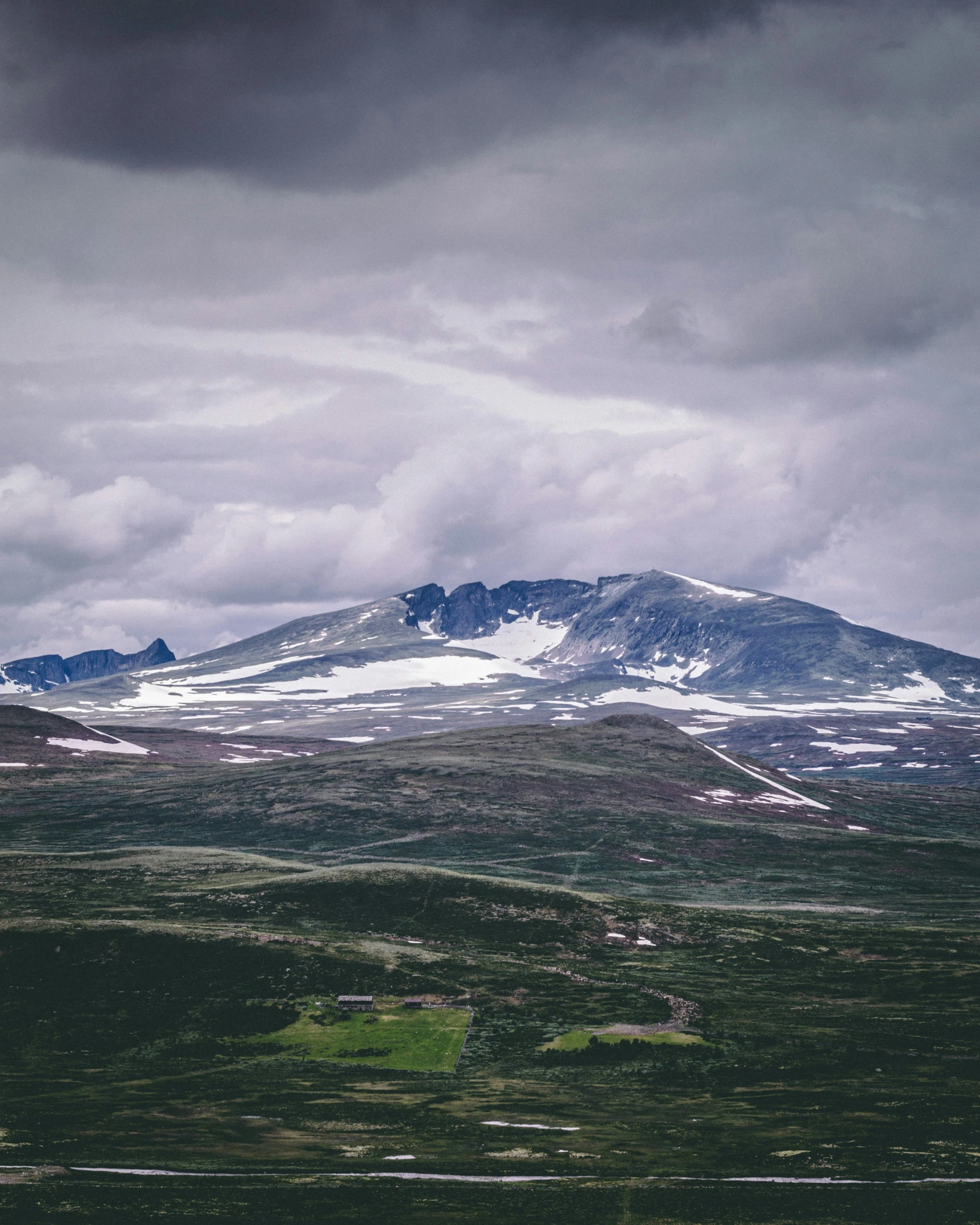 an aerial view of some mountains covered in snow