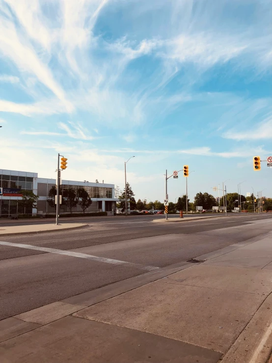 an empty intersection near a building and several street signs