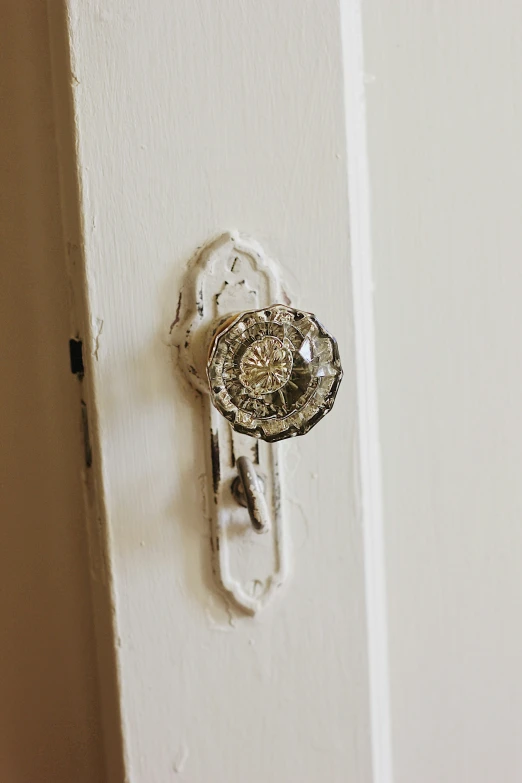 a metal door with a fancy diamond ring on it