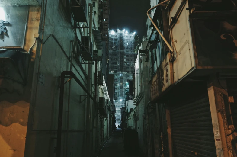 an alley is lit up at night with a sky scr