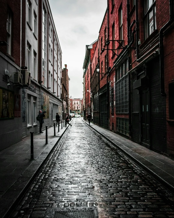 a narrow cobblestone street with buildings near it