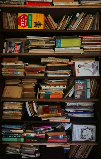 a bookshelf filled with lots of assorted books