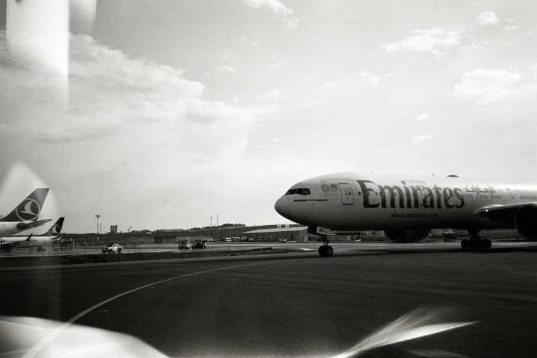 black and white pograph of a delta plane at an airport