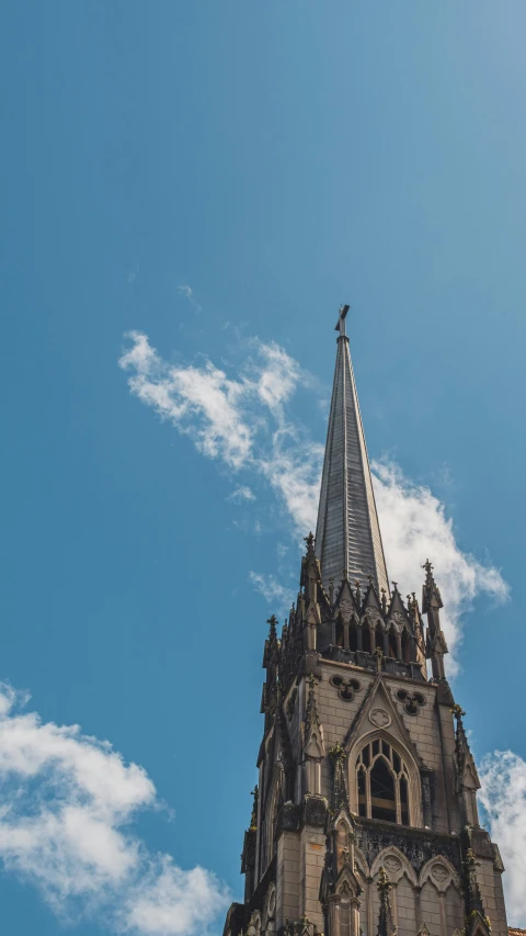 a steeple of a building against a blue sky