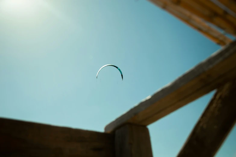 a parasail kite in the sky next to a deck