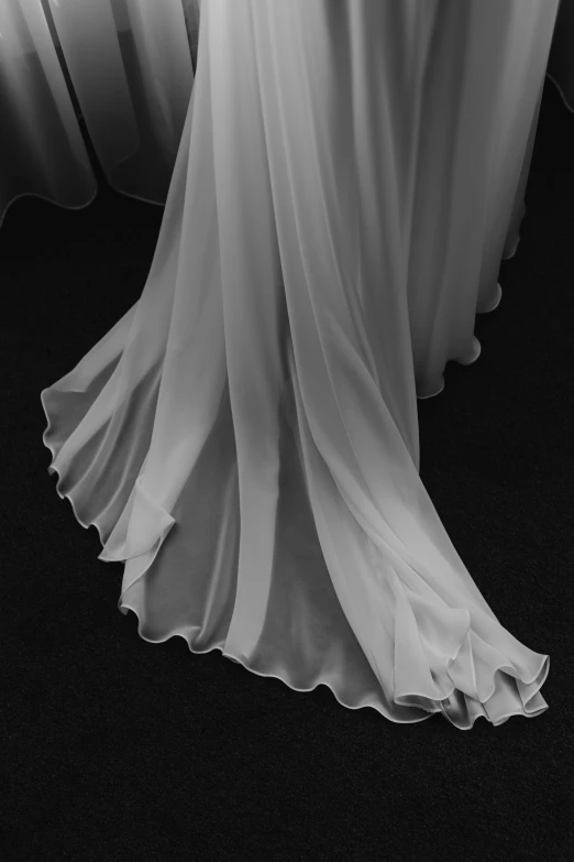the back end of a sheer - lined wedding gown