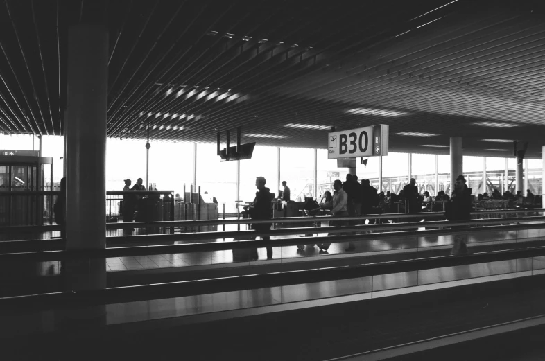 people stand at the airport and look at the luggage