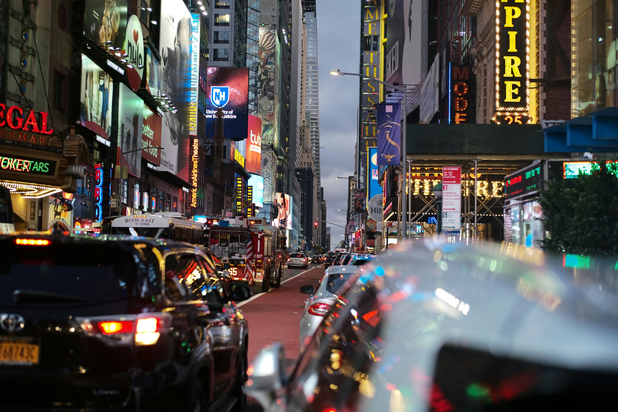 view of a busy city street with large buildings and traffic