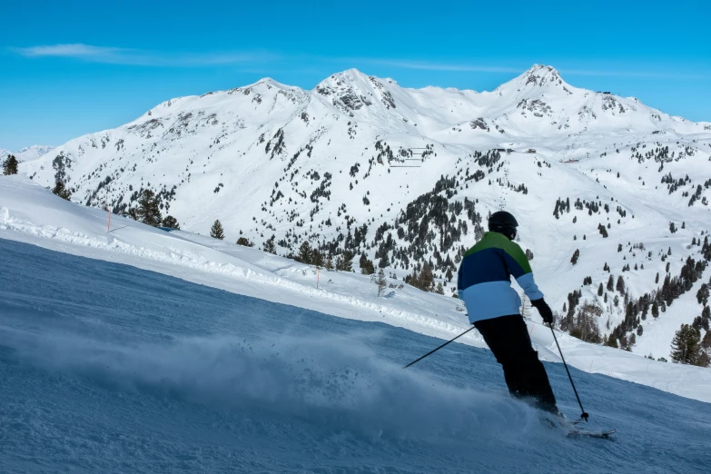 the man is skiing down the slope on skis