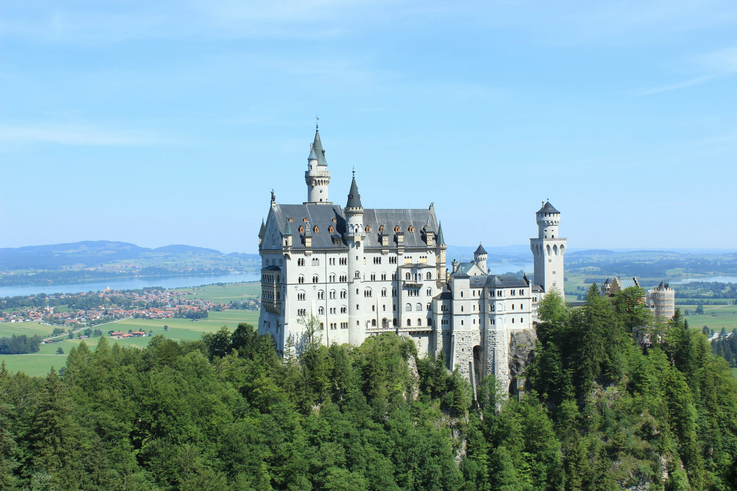 a castle on top of a mountain near the water