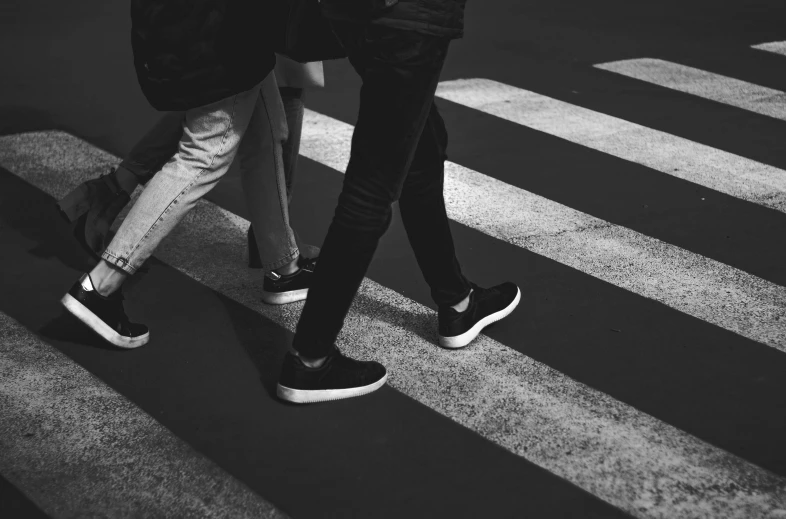 people cross the street while walking in the crosswalk