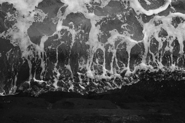 an aerial po of a black and white ocean