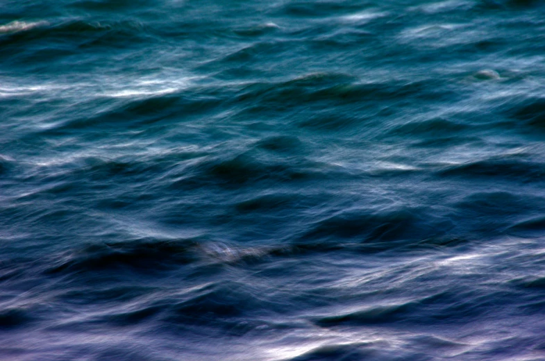 a large body of water with small waves on the surface