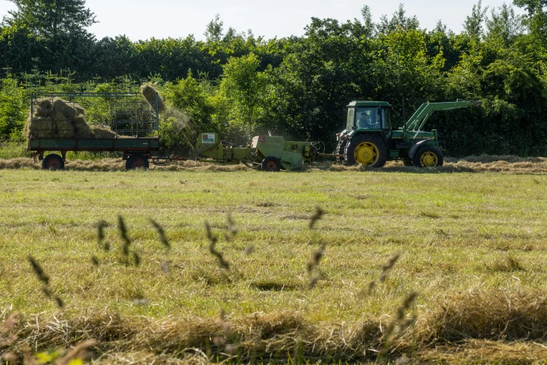 tractor and trailer parked in large grass field