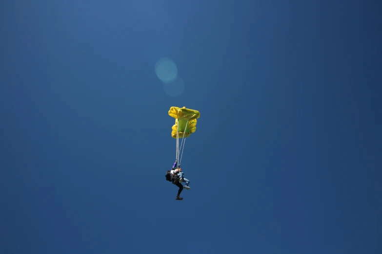 a person flying up in the air on top of a kite