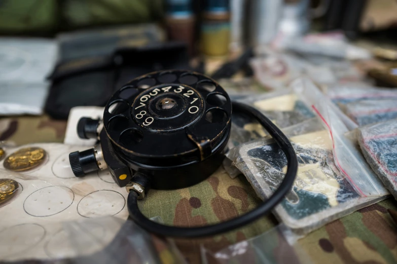 a rotary watch sits on a camouflage cloth