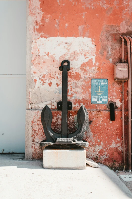 an anchor is next to an orange wall