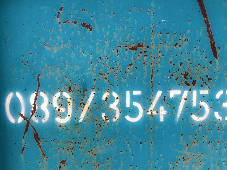 an old metal plate with numbers on it