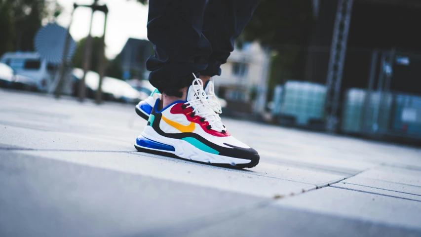 a person's feet with the rainbow nike air max