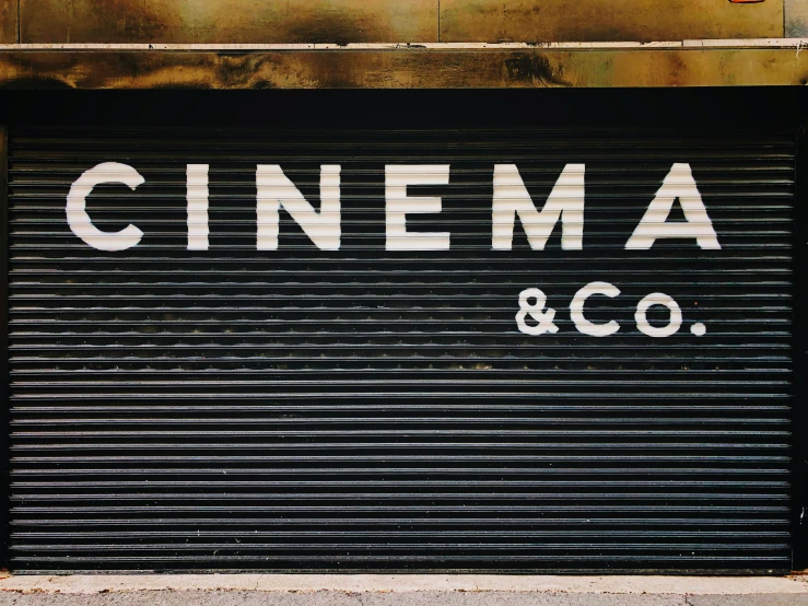 a sign that says cinema and co on the side of a building