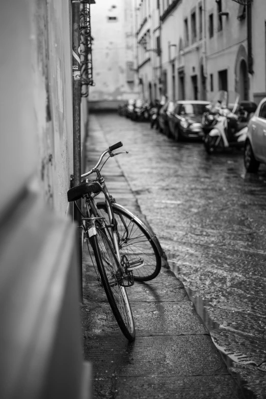 a bike is  to a wall and is parked