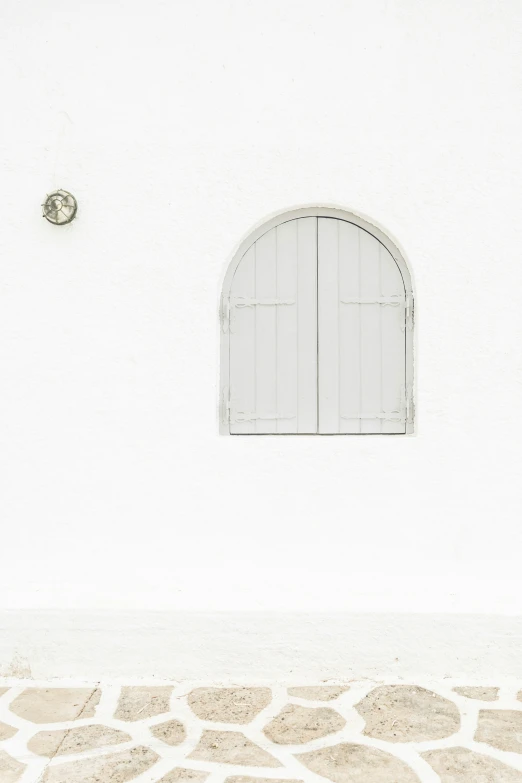 a window with the shutters open above stone flooring