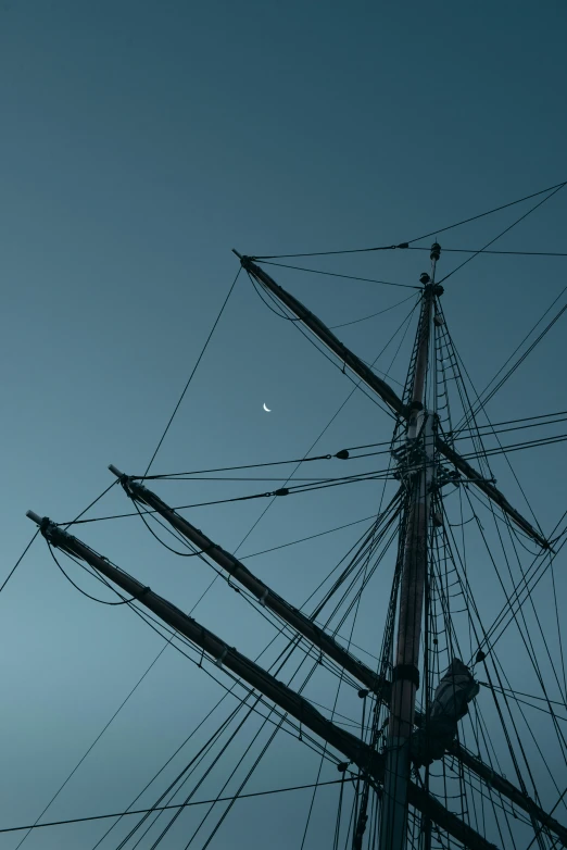 mast of sailing ship in the sky at dusk