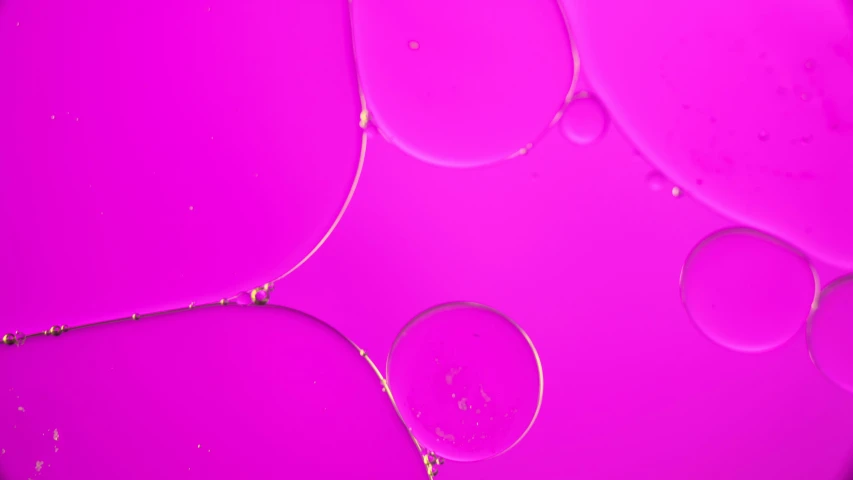 a view of a pink background, it looks like the water droplets are drops
