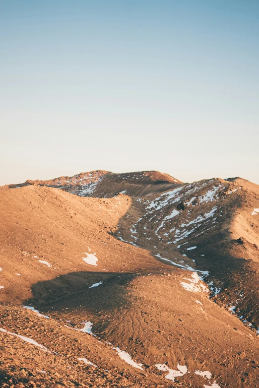 snowy mountain peaks against a sunny blue sky