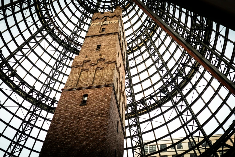 a tall clock tower sitting below a glass dome