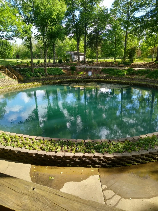 a small pool with large water in a park