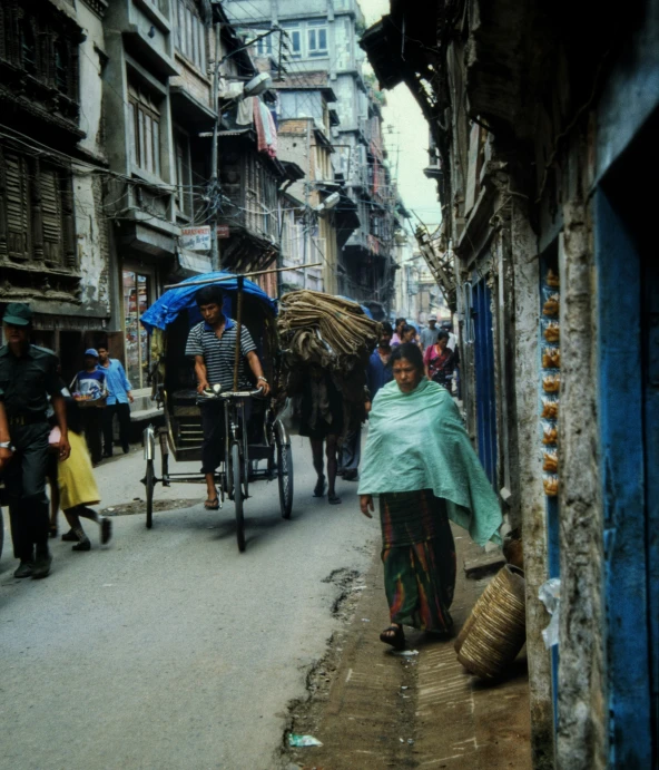 an indian lady is walking with her baby and people