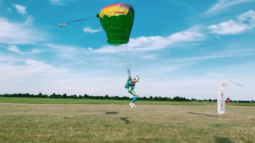 a person on a field holding onto a parachute