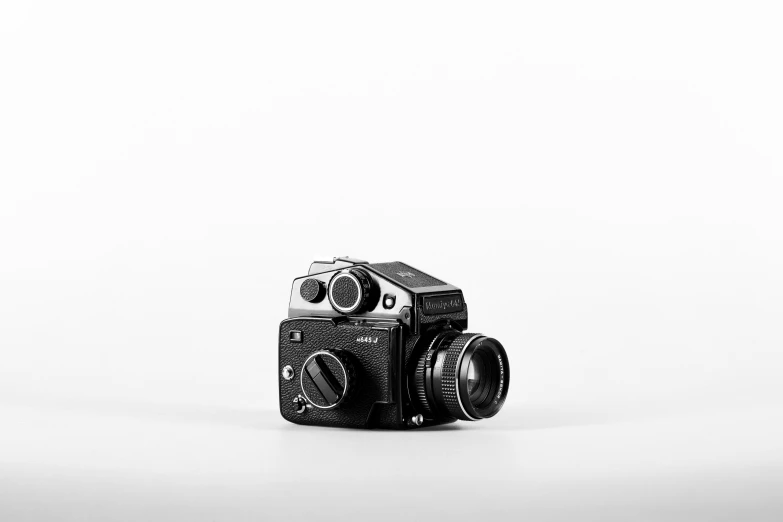 an old fashioned camera is sitting in a white background