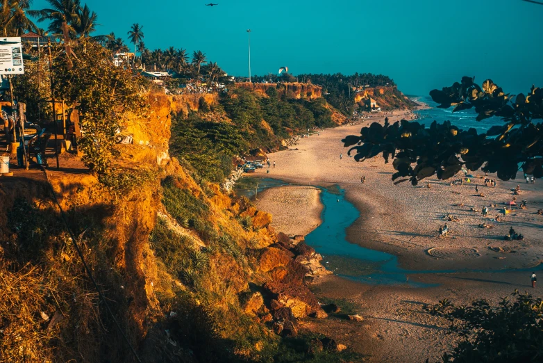 an aerial view of the beach, with people walking around