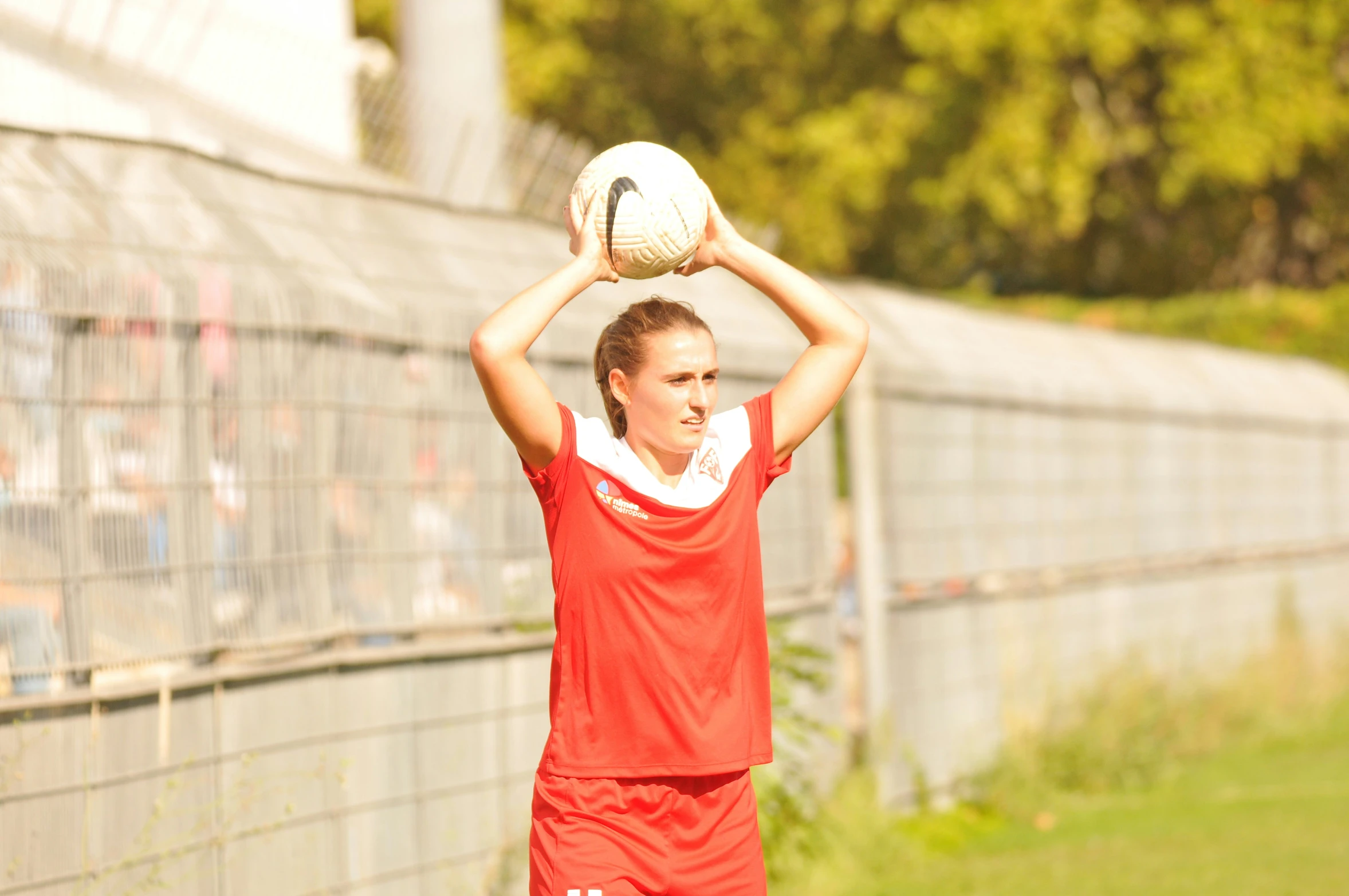 a girl is preparing to throw a soccer ball