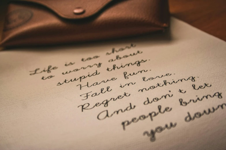 handwritten note on paper with purse and pen