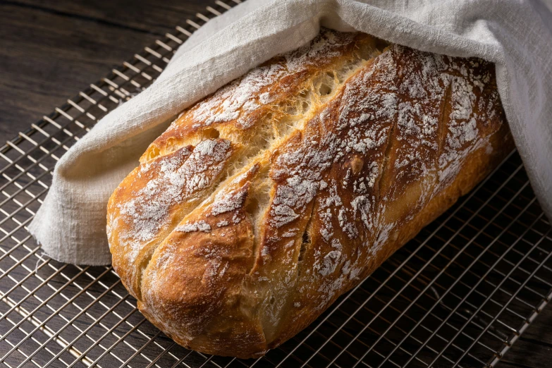 a loaf of bread and a napkin on a cooling rack