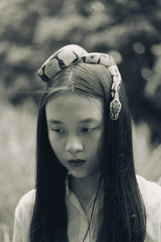 a young woman with a long dark hair and a bandanna on her head