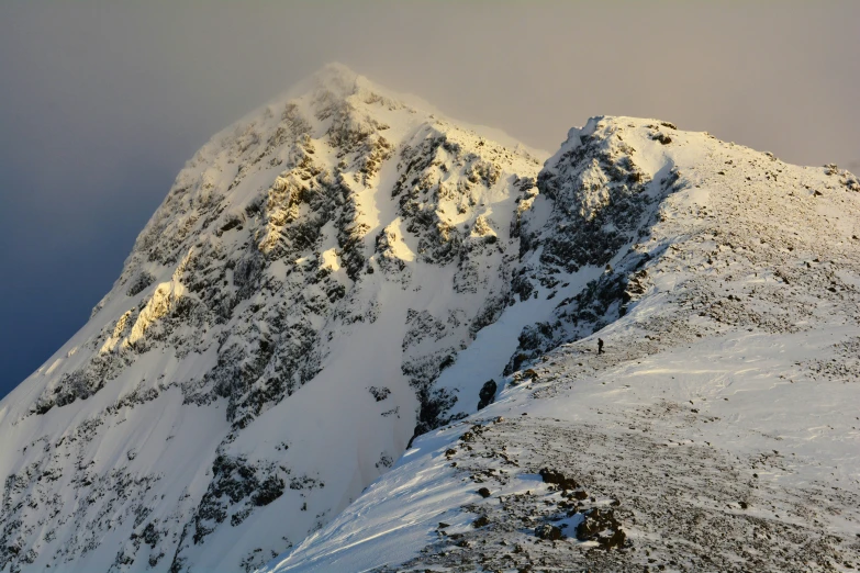 a snowy mountain peak is pictured from the bottom