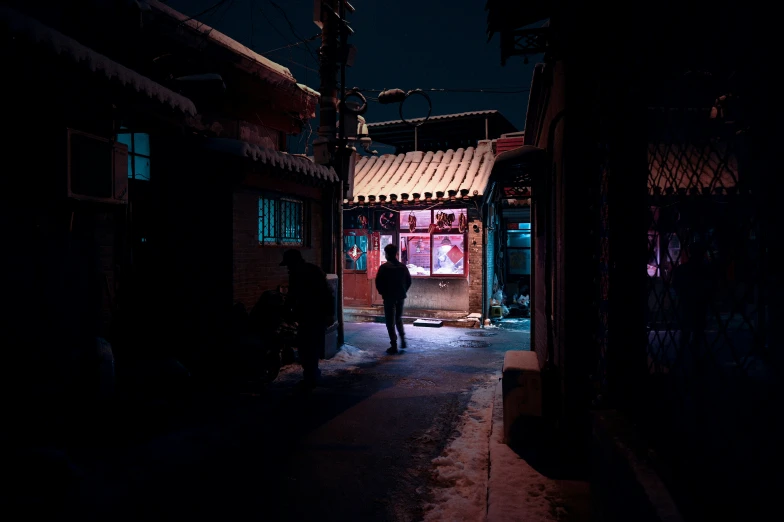 a person walking through the dark streets with his head down