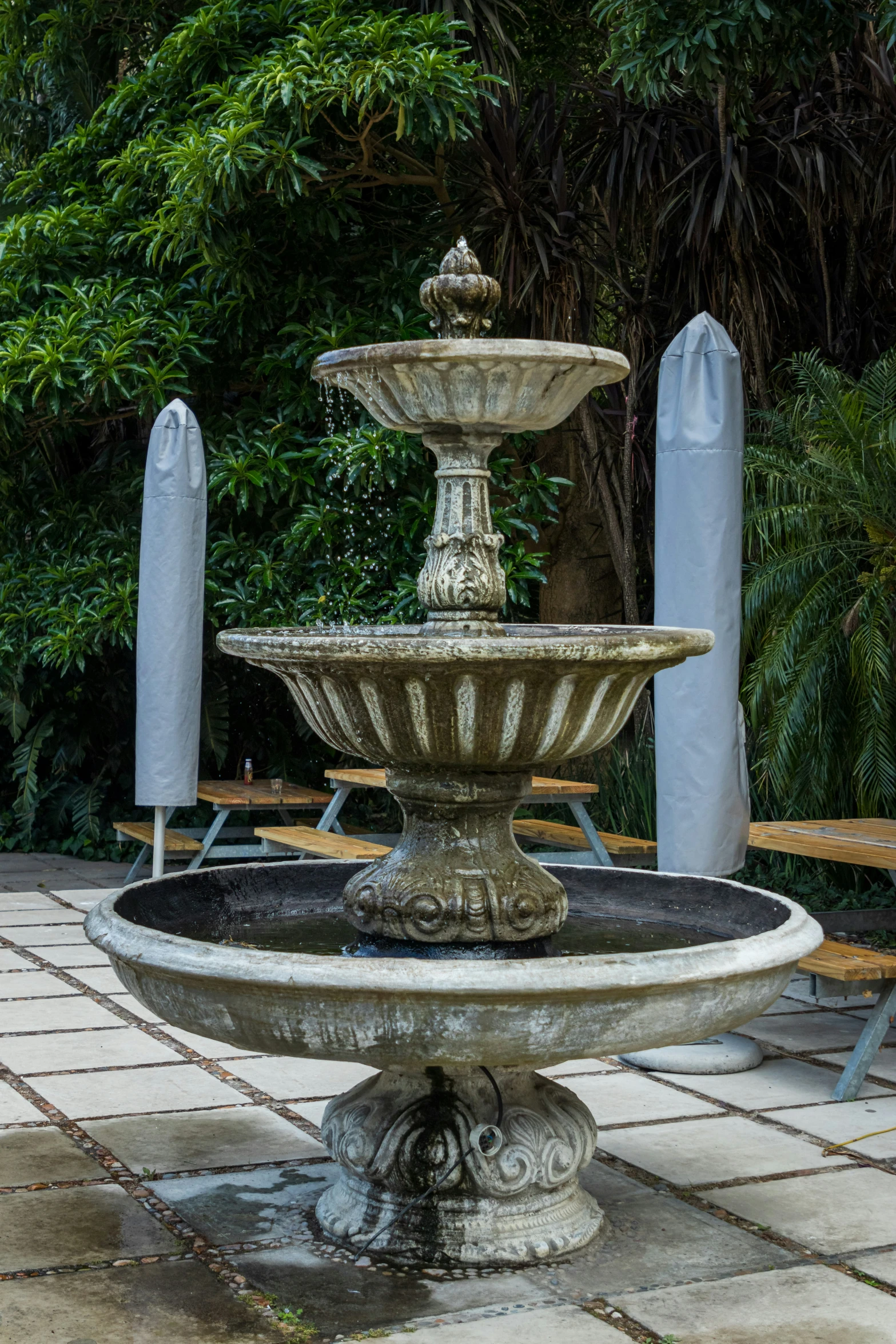 a water fountain is placed in an outdoor area