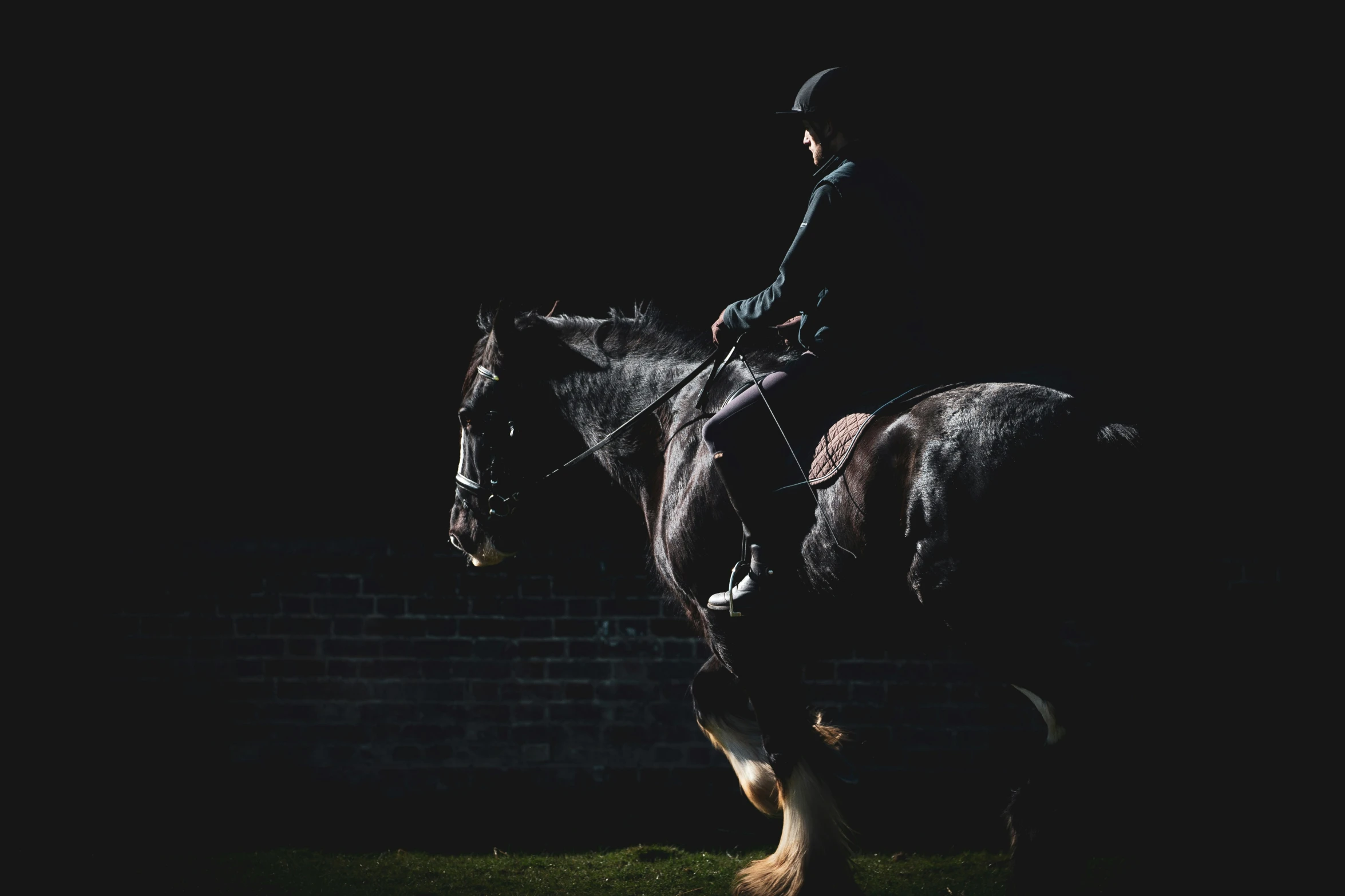 a woman is riding a horse outside in the dark