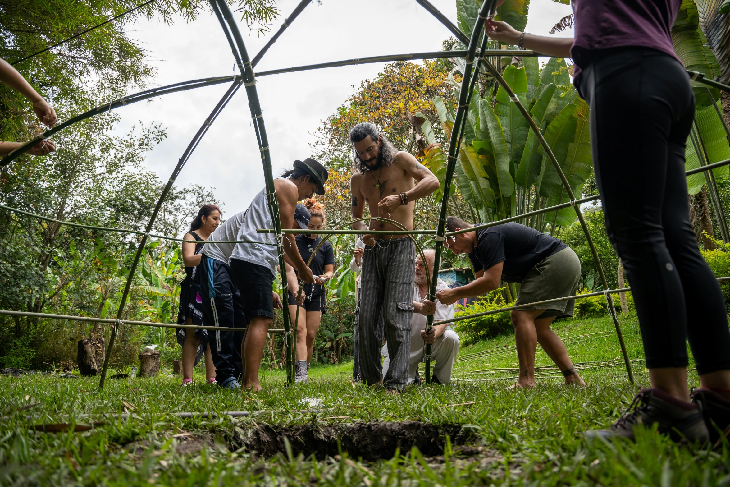 a group of people in a garden under a tunnel