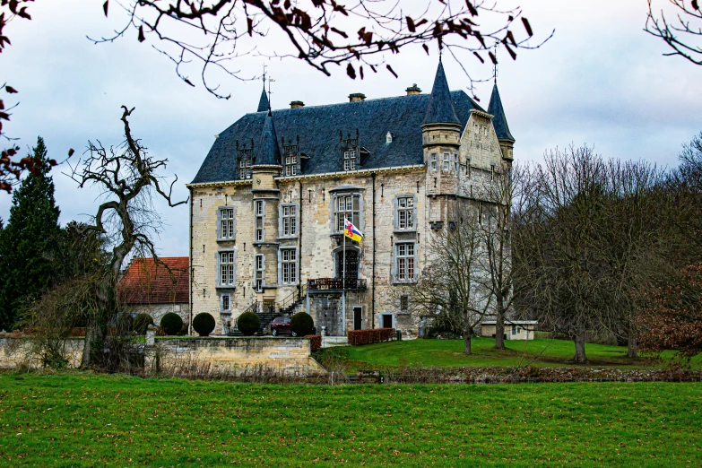 this is an old mansion with a blue roof and a turret