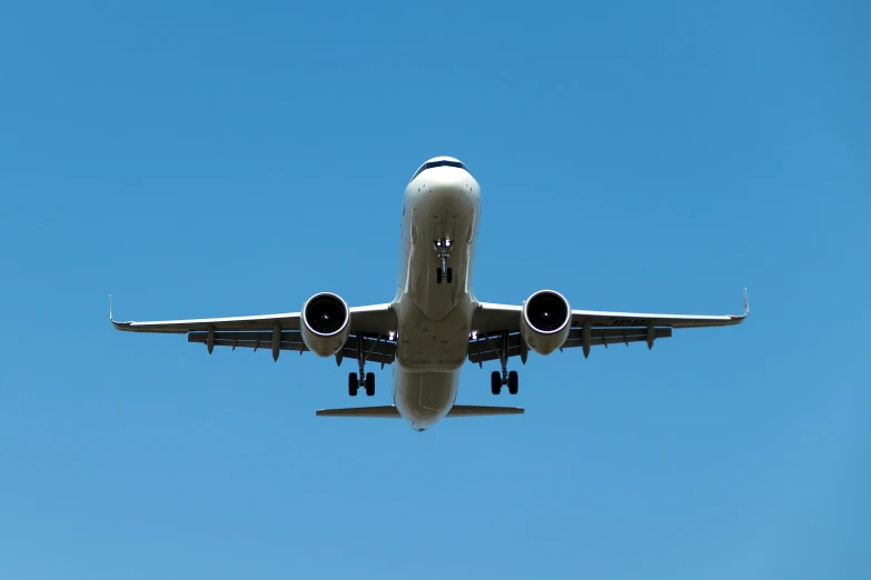 an airplane flying in the blue sky is almost completely covered