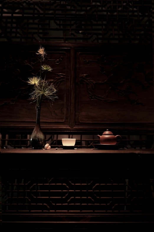 the flowers are sitting on a table in the dark