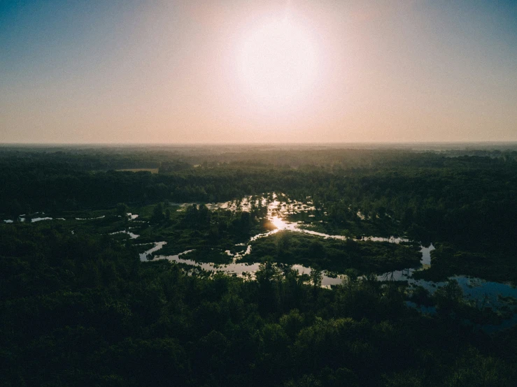 an aerial view looking down on a river and mountains at sunset